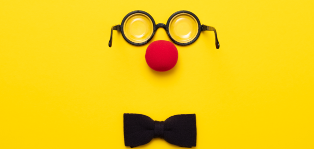 An image of a clown nose, glasses and bow tie for an article about clowning for actors.