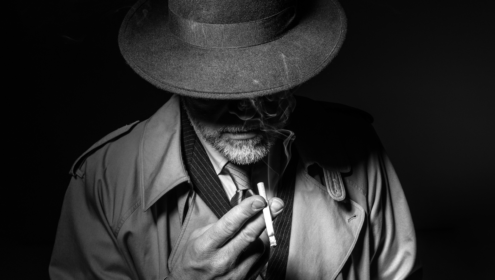a black and white image of a man smoking a cigarette
