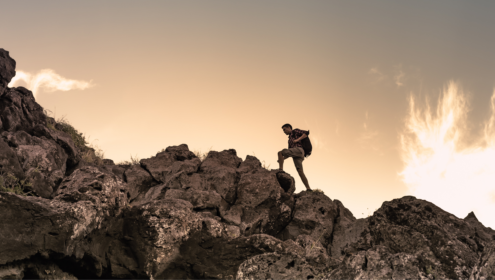a man climbing up a rocky slope towards a goal that one might call a super objective?
