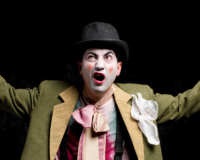 an actor, angry, in clown costume and make-up