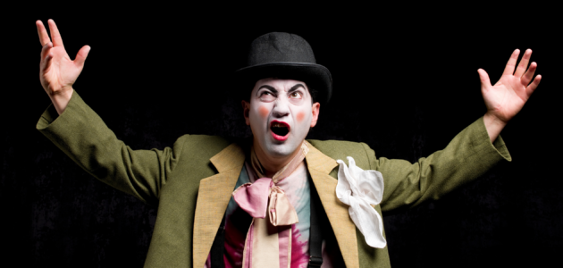 an actor, angry, in clown costume and make-up