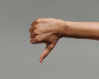a hand giving a 'thumbs down' sign against a blank backtround