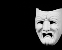 a tragedy mask, clearly looking upset about some bad acting