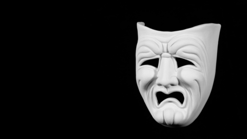 a tragedy mask, clearly looking upset about some bad acting
