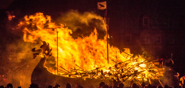 a viking longship burning in front of a crowd. the sort of thing you might encounter while looking up how to audition for vikings