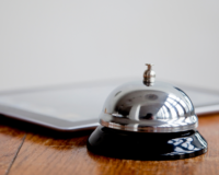 a hotel bell and ipad, presumably for someboyd checking in