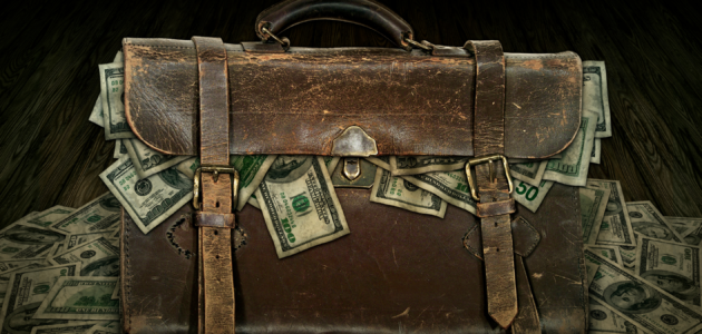 a bag overflowing with paper money