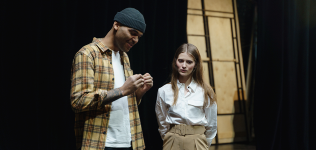 two actors running scenes on stage. perhaps some beginner scripts for actors?